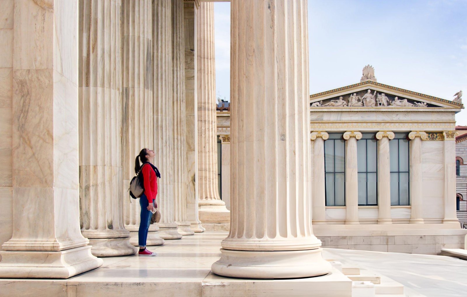 girl-looks-up-at-the-ceiling-under-the-columns-of-the-athenian